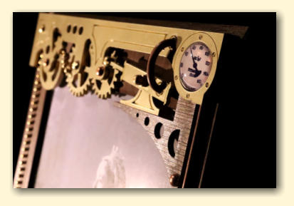 The gears, piston and glass gauge situated across the top of the frame