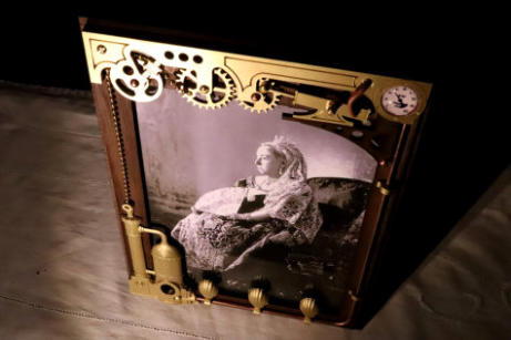 A view from the top of the frame containing a portrait of Queen Victoria