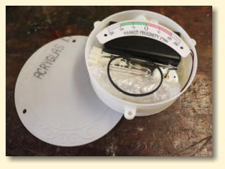 An open unassembled gauge kit showing all the parts inside