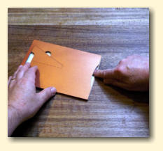 Press down the glue or tape from the top of the pocket
