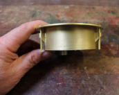 The side of the gauge showing the brass M4 fixing screws