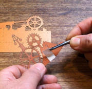 Remove the backing from the tape on the Gears Cutout