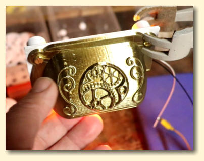 The 3D printed lampshade in brass filament with an amazing embossed gear design