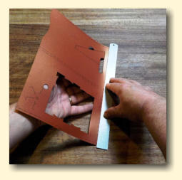 Holding the ruler firmly, fold up the rest of the cutout