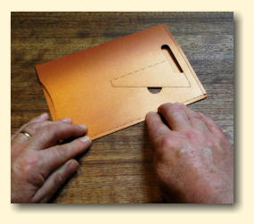 Smooth down the whole pocket cutout again and press firmly along the taped edge