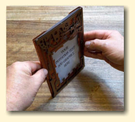 Whilst leaning the holder backwards, tap it ona table to ensure the message has dropped to the bottom