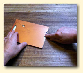 Press down the glue or tape from the top of the pocket