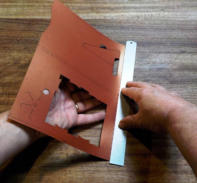 Holding the ruler firmly, fold up the rest of the cutout