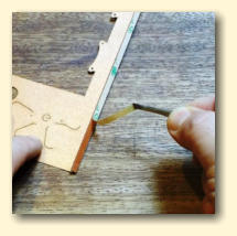 Peel the backing off the tape on the side edge
