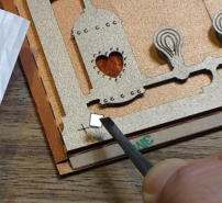 Stick a foam pad on each cross