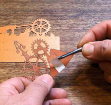 Remove the backing from the tape on the Gears Cutout
