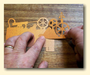 Carefully line up the Gears Cutout with the markings on the Base Cutout