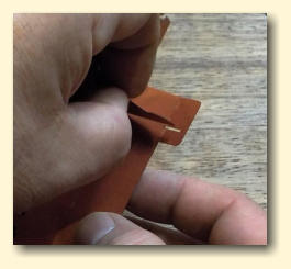 Line the support up with the slotted tab