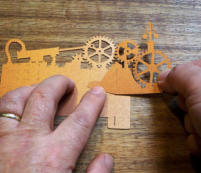 Carefully line up the Gears Cutout with the markings on the Base Cutout